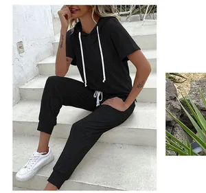 Close-up detail of black short-sleeved hoodie set featuring contrasting white drawstrings