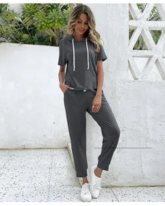Detail of dark grey short sleeve hoodie and matching joggers on outdoor model