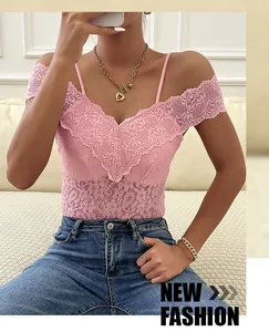 Close-up of pink lace bodysuit with delicate floral patterns and spaghetti straps