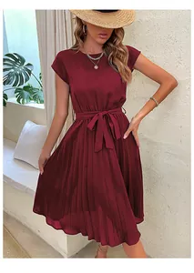 Detailed view of wine red pleated dress with elegant waist tie and satin-like texture