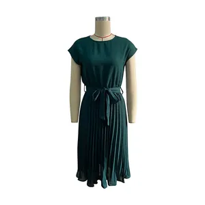 Detail of dark green pleated summer dress featuring round neck and waist tie bow