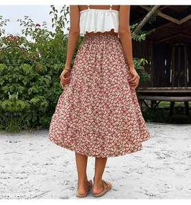 Detail of red floral midi skirt featuring layered ruffle hem and elastic high waist