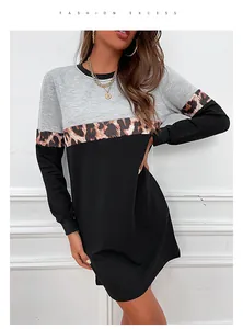 Detail of three-tone patchwork dress featuring leopard print strip and long sleeves