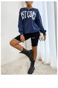 Detail of navy blue sweatshirt featuring bold white West Coast letter print on chest