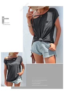 Detail of grey off-shoulder t-shirt featuring hollow-out shoulder and chest pocket