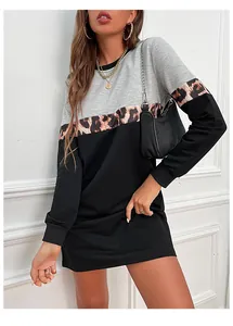 Close-up of long sleeve dress featuring color-block panels and leopard print fabric