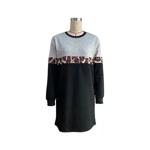 Detail view of long sleeve sweatshirt dress with grey, leopard print, and black patchwork