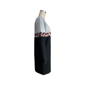 Detail view of women's long sleeve color block dress with leopard print stripe and grey top
