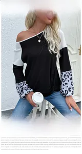 Detail of waffle knit fabric and leopard print lantern sleeves on colorblock top