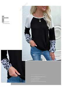 Detail of waffle knit fabric and leopard print cuffs on this color block casual top