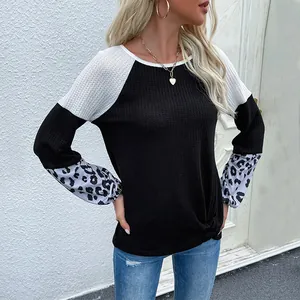 Women's waffle knit long sleeve top with color block design, leopard cuffs and front knot