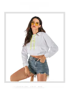 Detail of white cropped hoodie featuring neon yellow drawstrings and Hey letter print