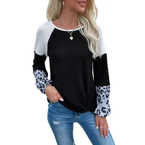 Women waffle knit pullover sweater with leopard print sleeves and twist knot hem detail