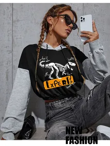 Detail of hoodie showing dinosaur skeleton print with expert text and contrast sleeves