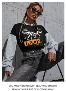 Detail of cropped hoodie featuring dinosaur skeleton print and orange EXPERT text