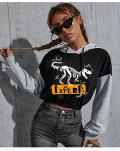 Detail of cropped hoodie featuring dinosaur skeleton print and contrast raglan sleeves