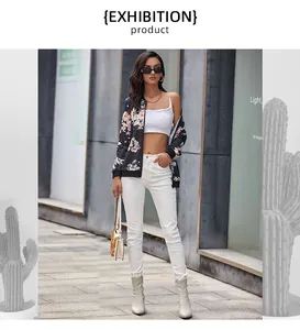 Chic women's vintage floral bomber jacket paired with white high-waist trousers and boots