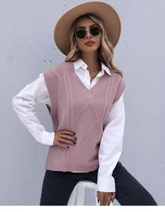 Detail of pink V-neck knit vest featuring classic cable knit and argyle pattern texture