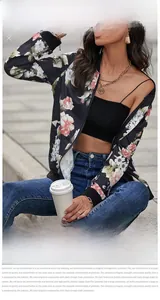 Outdoor street style shot of a black jacket with large pink and white floral patterns