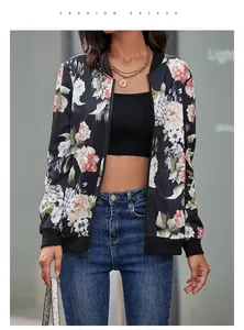 Detail of vintage floral print and ribbed cuffs on a black women's zip-up baseball jacket
