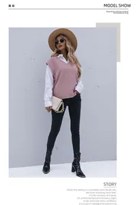 Street style shot of pink argyle knit vest paired with white shirt and brown fedora