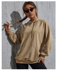Close-up of camel oversized hoodie featuring kangaroo pocket and ribbed cuffs in soft cotton