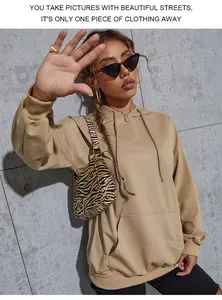 Close-up of oversized khaki hoodie with kangaroo pocket and adjustable drawstrings