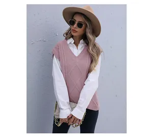 Detail of pink V-neck knit vest with cable patterns and diamond weave texture