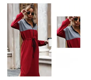 Detail of color-block dress with drawstring waist, half-zip collar and side slit
