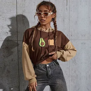 Detail of color-block cropped hoodie featuring avocado and toast cartoon print and hood