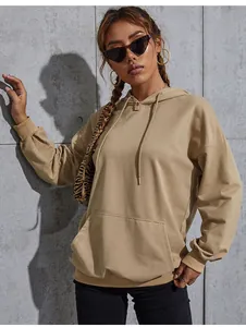 Close-up of khaki oversized hoodie featuring a front kangaroo pocket and ribbed cuffs