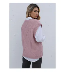 Detailed side view of pink cable knit vest showing texture and ribbed side hem details