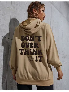 Detail view of khaki oversized hoodie back featuring black letter print and smiley face pattern