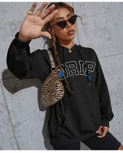 Detail of black butterfly hoodie showing drip letter print and street style kangaroo pocket