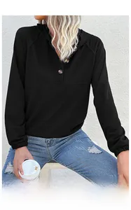 Detail of the hooded neckline with three dark buttons on a black women's sweatshirt