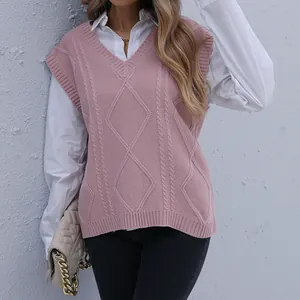 Pink V-neck cable knit vest with white long sleeve shirt for a layered autumn style