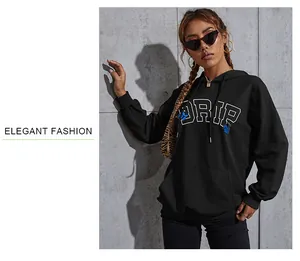 Close-up of the black hoodie featuring white DRIP lettering and a blue butterfly print