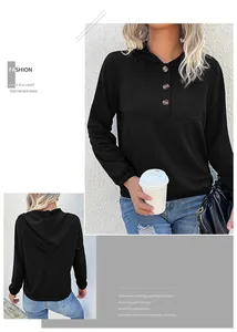 Detail of black women's hoodie showing the buttoned neckline and long drop shoulder sleeves