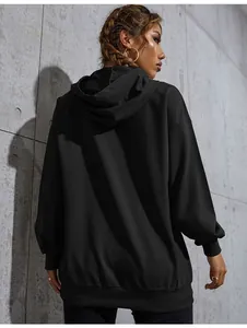 Detailed back view of a black oversized hoodie with ribbed cuffs and a large hood