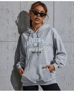 Detail of grey hoodie featuring vintage California West Coast graphic and kangaroo pocket