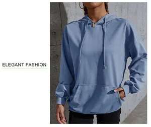 Detail of blue drawstring hoodie showing soft knit fabric and front kangaroo pocket