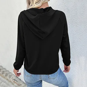 Back view of a black long-sleeve hoodie with raglan sleeves and a minimalist hood design
