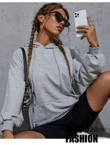Close-up of light gray oversized hoodie with kangaroo pocket and ribbed sleeve cuffs
