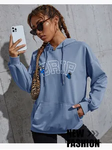 Detail of blue butterfly and DRIP print on dusty blue hoodie with kangaroo pocket