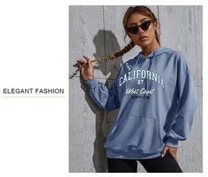 Close-up detail of oversized foggy blue hoodie with California 87 graphic and front pocket