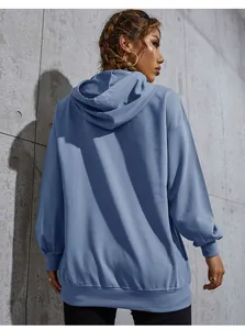 Rear view of dusty blue oversized hoodie showing textured fabric and ribbed hem detail