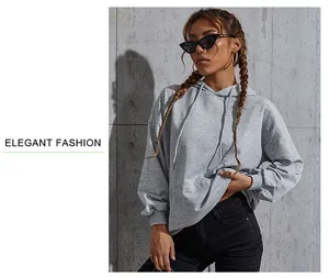 Detail of light gray oversized hoodie with adjustable drawstrings and ribbed cuffs
