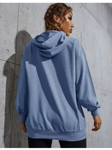 Back view of a fog blue oversized hoodie featuring dropped shoulders and ribbed knit cuffs