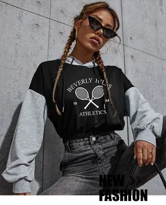 Close-up of contrast cropped hoodie with Beverly Hills Athletics print and drawstring hood