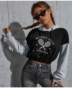Close-up of contrast grey and black cropped hoodie with Beverly Hills athletics print